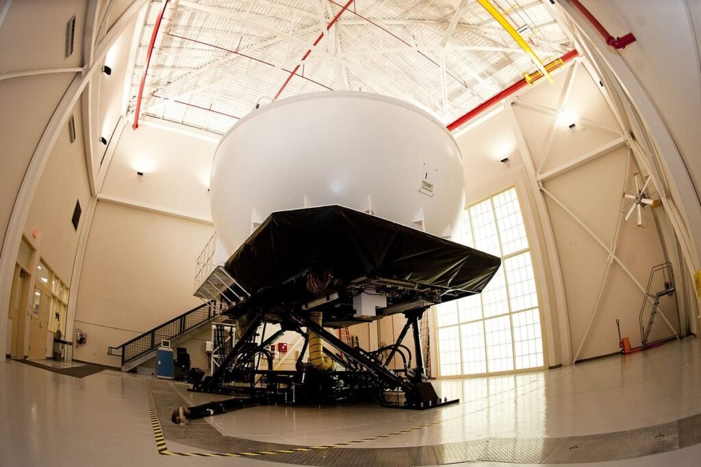 KC-135R full flight simulator on its motion platform inside a bright training bay